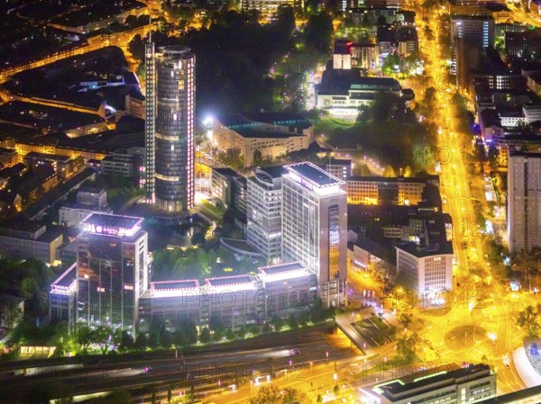 Aerial view, Westenergie tower at the main station, Essen-Holsterhausen, Essen, Ruhr area, North Rhine-Westphalia, Germany, outdoor lighting, railway station, DE, Deutsche Bahn AG, twilight, Europe, commercial buildings, main station, central station, light pollution, aerial photograph, aerial photography, aerial photography, night aerial photograph, streetlights, street lamps, tower, overview, bird's eye view, illuminated, illuminated houses, illuminated house, birds-eyes view, artificial light, night, nightflight, overview