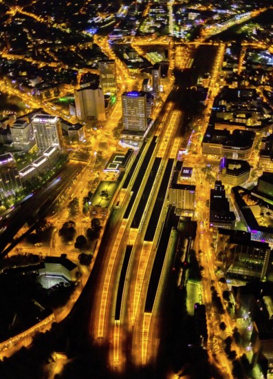 Aerial view, Essen central station, south-east quarter, Essen, Ruhr area, North Rhine-Westphalia, Germany, outdoor lighting, railway station, DE, Deutsche Bahn AG, twilight, Europe, commercial buildings, central station, main station, light pollution, aerial photograph, aerial photography, aerial photography, night aerial photograph, streetlights, street lamps, overview, bird's eye view, illuminated, illuminated houses, illuminated house, birds-eyes view, artificial light, night, nightflight, overview