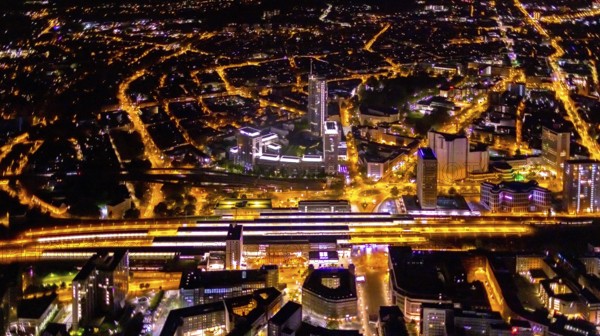 Aerial view, Essen central station, business district, Westenergie tower, demolition Ypsilon-Haus, Essen-Holsterhausen, Essen, Ruhr area, North Rhine-Westphalia, Germany, outdoor lighting, railway station, construction work, construction site, building site, construction project, construction site, DE, Deutsche Bahn AG, twilight, Europe, commercial buildings, central station, main station, light pollution, aerial view, aerial photography, aerial photography, night aerial photography, streetlights, street lamps, tower, overview, bird's eye view, illuminated, illuminated houses, illuminated house, birds-eyes view, artificial light, night, nightflight, overview