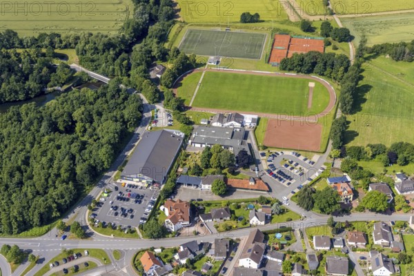 Aerial view, Edeka supermarket local supply centre, sports field Niederense, Hubertushalle Schützenverein, Niederense, Ense, Sauerland, North Rhine-Westphalia, Germany, DE, Edeka supermarket, shopping markets, shopping place, shopping centre, Europe, football field, football stadium, aerial view, aerial photography, aerial photography, local supply centre, parking, Schützenbruderschaft, Schützenbruderschaft St. Hubertus 1824 Niederense, Schützenhalle, Schützenverein, sports, sports facilities, sports field, sports centre, supermarket, tennis, tennis facility, tennis courts, overview, bird's-eye view, overview