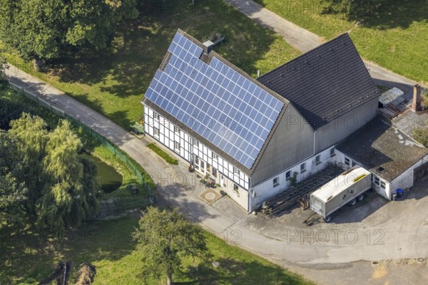 Aerial view, half-timbered house with solar roof in Oberhülsenbecke in the district Rüggeberg in Ennepetal, Ruhr area, North Rhine-Westphalia, Germany, DE, Ennepetal, Europe, property tax, real estate, aerial view, aerial photography, aerial photography, photovoltaic, photovoltaic system, solar, solar system, solar roof, solar energy, overview, bird's eye view, residential complex, living and life, residential buildings, quality of life, birds-eyes view, overview