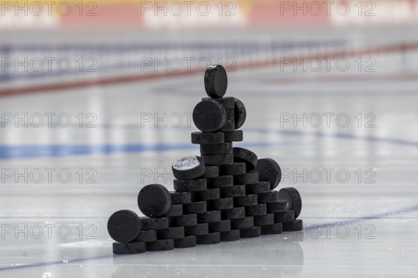 Symbolic picture DEL (German Ice Hockey League) : Close-up of pucks stacked on the ice for play-in
