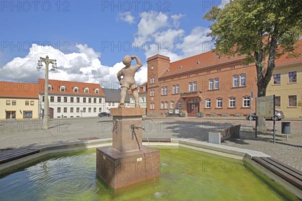 Market fountain with juice boy, symbol of historical drinking water supply, boy drinking, town hall, market, Zörbig, Saxony-Anhalt, Germany