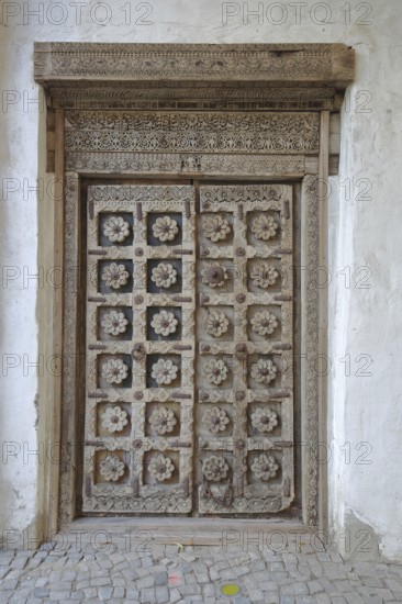 Door with wood carvings and floral decorations, castle, Wanzleben, Romanesque Road, Saxony-Anhalt, Germany