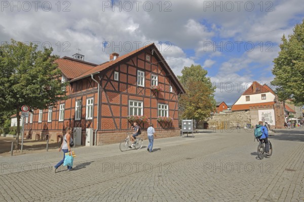Volksbank building, half-timbered house, historic Hague Gate, pedestrians, cyclists, Haldensleben, Saxony-Anhalt, Germany