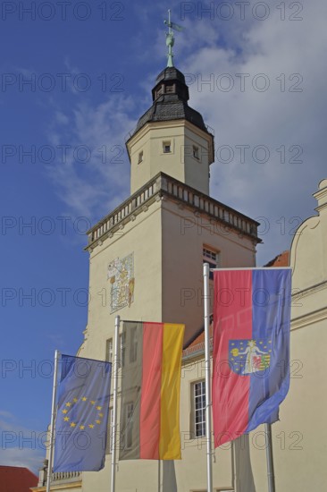 Renaissance town hall with EU flag, German national flag and town flag, three, flags, sundial, wall mosaic, town coat of arms, Coswig, Fläming, Saxony-Anhalt, Germany