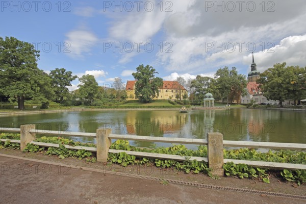 Castle and pavilion at the spa park pond with church tower of the town church, Goethe School, Goethe Park, Bad Lauchstädt, Saxony-Anhalt, Germany