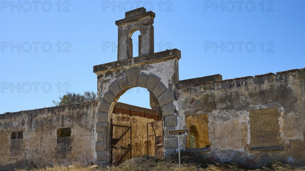 Dilapidated archway of an old factory, surrounded by crumbling walls under a clear sky, Old silk factory, German Wehrmacht military prison, concentration camp, Lost Place, Kattavia, Rhodes, Dodecanese, Greek Islands, Greece