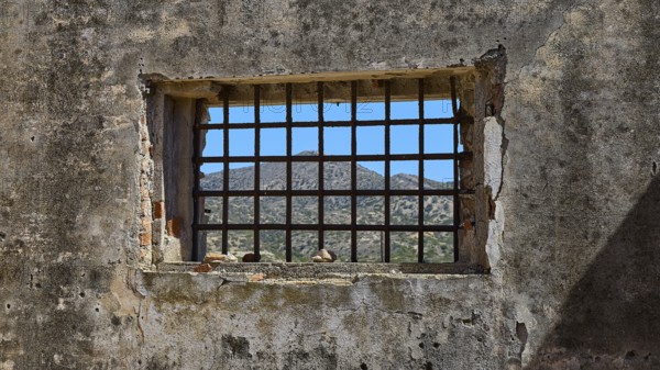 View through a barred window onto a mountain landscape, Old Silk Factory, German Wehrmacht military prison, Concentration Camp, Lost Place, Kattavia, Rhodes, Dodecanese, Greek Islands, Greece
