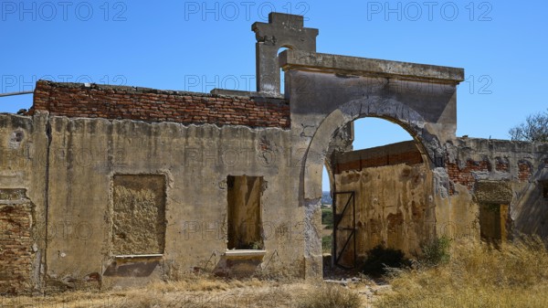 Faded walls with a central archway surrounded by wild vegetation, Old Silk Factory, German Wehrmacht military prison, Concentration Camp, Lost Place, Kattavia, Rhodes, Dodecanese, Greek Islands, Greece