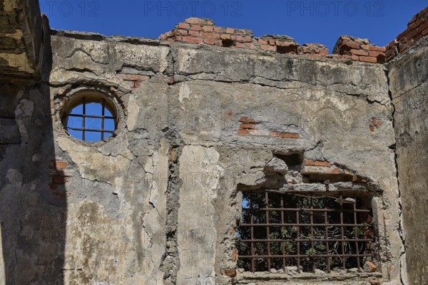 Old walls with round and rectangular lattice window, surrounded by bricks, Old silk factory, Military prison of the German Wehrmacht, Concentration camp, Lost Place, Kattavia, Rhodes, Dodecanese, Greek Islands, Greece