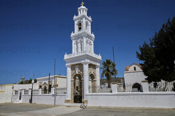 Church of Agia Paraskevi, A magnificent white church tower rises into the clear blue sky, village of Kattavia, southern tip of Rhodes, Rhodes, Dodecanese, Greek Islands, Greece