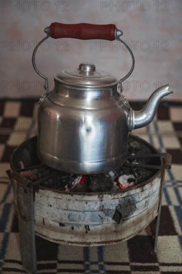 Olodschool kettle on the stove with fire charcoal