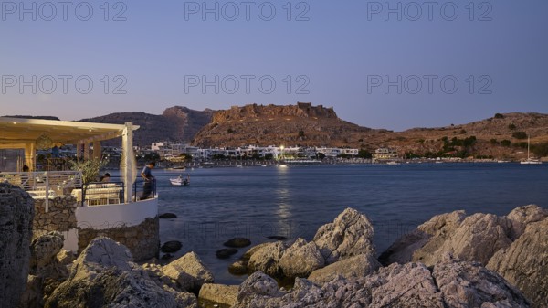 Feraklos fortress, view of an illuminated coastal town at night with rocks in the foreground, bay, Charaki, Haraki, east coast Rhodes, Rhodes, Dodecanese, Greek Islands, Greece