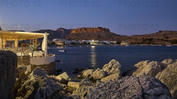 Argo restaurant, Feraklos fortress, night view of a castle above a quietly lit coastal town by the sea, Charaki bay, Haraki, east coast of Rhodes, Rhodes, Dodecanese, Greek islands, Greece