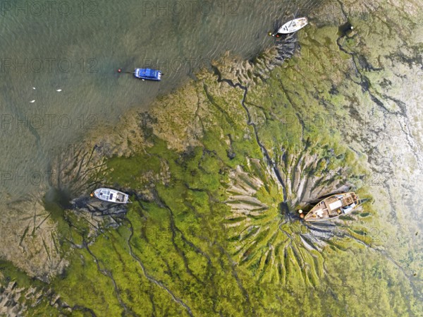 Top Down over boat and mud from drone, Paulsgrove Lake, Portchester Castle, Portchester, Fareham, Hampshire, England, United Kingdom