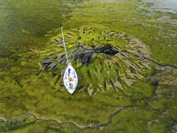 Top Down over boat and mud from drone, Paulsgrove Lake, Portchester Castle, Portchester, Fareham, Hampshire, EnglandDefault