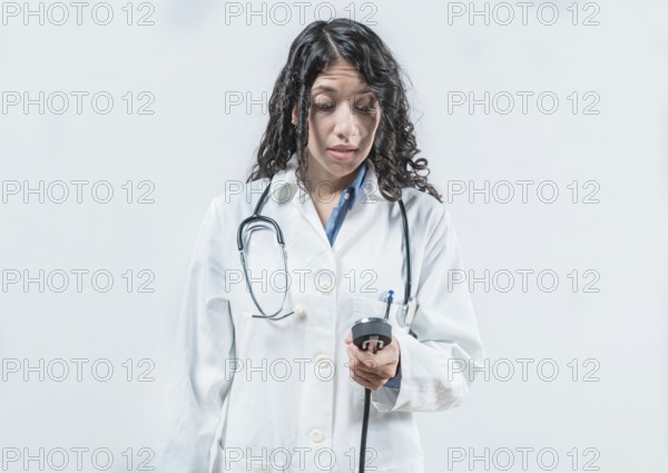 Surprised doctor with blood pressure monitor. Surprised female doctor with blood pressure monitor isolated