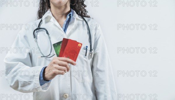 Doctor holding credit cards isolated. Unrecognizable doctor with credit cards, medical payment concept
