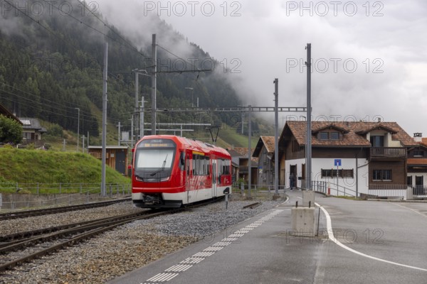 Metre-gauge electric low-floor multiple-unit trains of the Matterhorn-Gotthard Railway (MGB) ORION (Optimaler Regionalzug Im Oeffentlichen Nahverkehr) from Stadler, Sedrun station, Surselva, Grisons, Switzerland