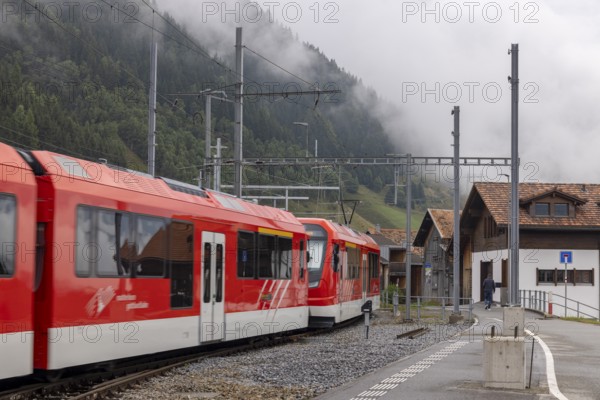 Metre-gauge electric low-floor multiple-unit trains of the Matterhorn-Gotthard Railway (MGB) ORION (Optimaler Regionalzug Im Oeffentlichen Nahverkehr) from Stadler, Sedrun station, Surselva, Grisons, Switzerland