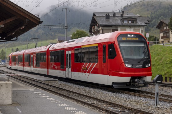 Metre-gauge electric low-floor multiple-unit trains of the Matterhorn-Gotthard Railway (MGB) ORION (Optimaler Regionalzug Im Oeffentlichen Nahverkehr) from Stadler, Sedrun station, Surselva, Grisons, Switzerland