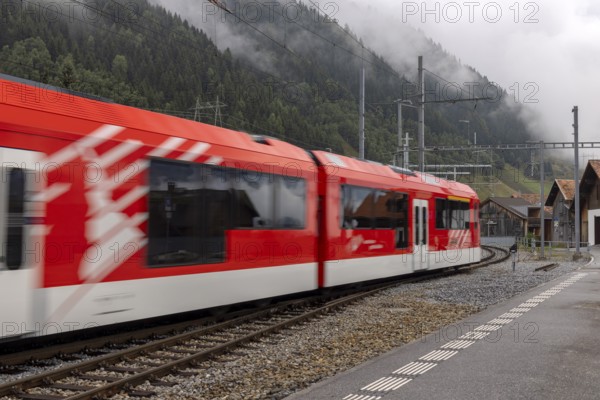 Metre-gauge electric low-floor multiple-unit trains of the Matterhorn-Gotthard Railway (MGB) ORION (Optimaler Regionalzug Im Oeffentlichen Nahverkehr) from Stadler, Sedrun station, Surselva, Grisons, Switzerland