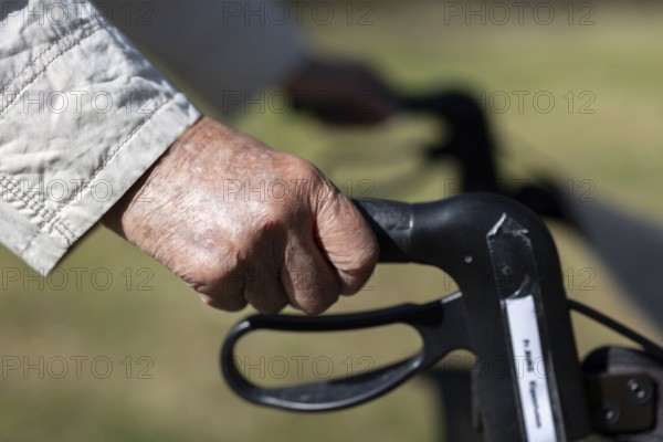 Close-up of wrinkled hands of a 90+ year old senior citizen in the park of a retirement home, Cologne, North Rhine-Westphalia, Germany
