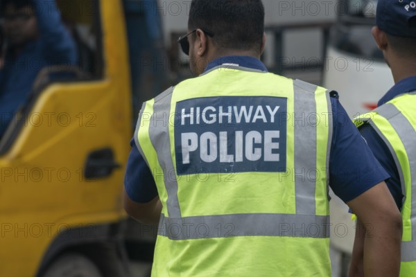 Highway police officer in a reflective vest directing traffic, Dhaka, Bangladesh