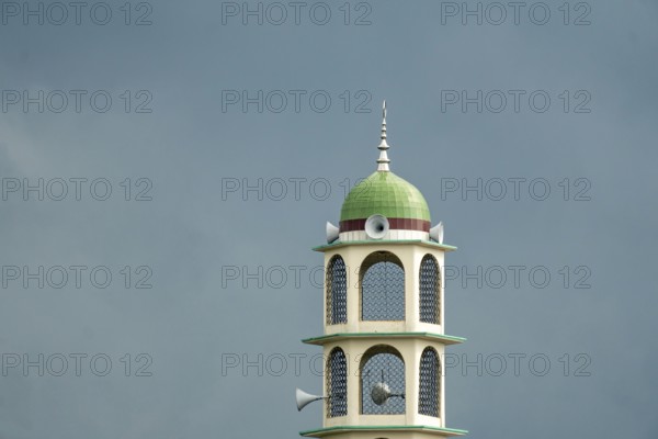 A tower with a dome and speakers against an overcast sky, Dhaka, Bangladesh