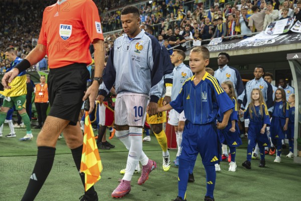 WROCLAW, POLAND - SEPTEMBER 5, 2025: Qualifications for FIFA 2026. Football match Ukraine vs France 0:2. Captain Mbappe Kylian with boy and team of France before the game