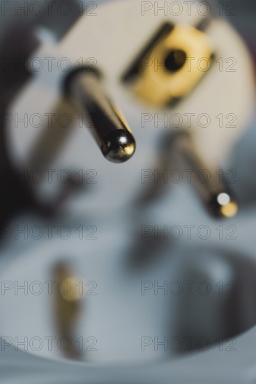 Close-up of a power plug, Schuko plug, with focus on the contact pins, symbol image for, electricity, electrical energy, power consumption, studio shot, Germany