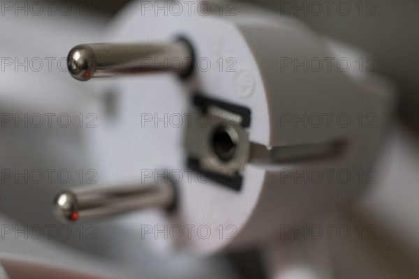 Close-up of a power plug, Schuko plug, with focus on the contact pins, symbol image for, electricity, electrical energy, power consumption, studio shot, Germany