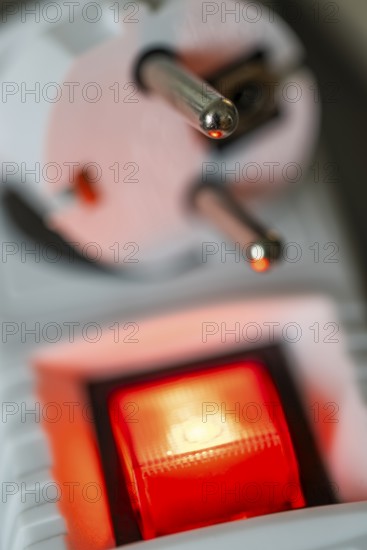Close-up of a white power plug, Schuko plug, on a multiple socket with red indicator light, symbolic image for electricity, electrical energy, power consumption, studio shot, Germany