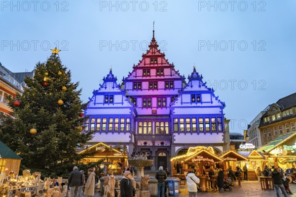 Christmas market at the colourfully illuminated Paderborn Town Hall at duskin Paderborn, North Rhine-Westphalia, Germany