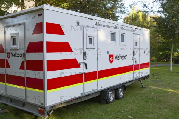 Borken, NRW, Germany, Mobile medical trailer of malteser parked on a lawn, offering medical aid and healthcare services