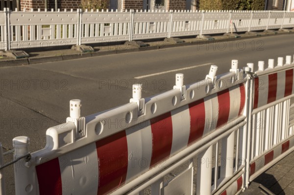 Borken, NRW, Germany, Red and white plastic roadblock securing a construction site, ensuring safety and preventing unauthorized access