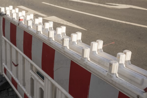 Borken, NRW, Germany, Red and white plastic roadblock closing a lane on an asphalt road during roadworks