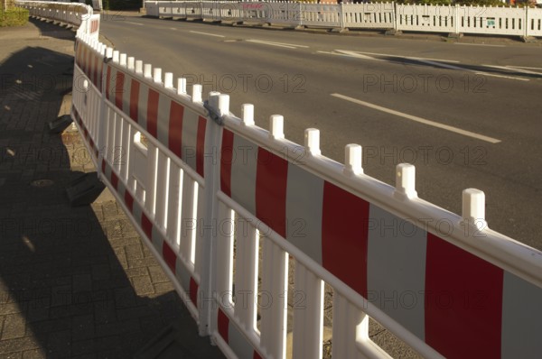 Borken, NRW, Germany, Red and white traffic barriers lining a paved road, guiding traffic flow and ensuring safety