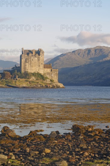 Historic castle on an inlet with dramatic mountains in the background, Eilean Donan Castle, Highlander, film set, Scotland, Great Britain