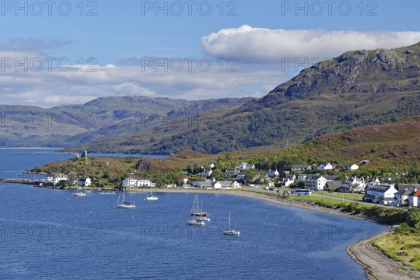 Coastal town with sailing boats at the harbour, mountains in the background, under blue sky, Kyle of Lochalsh, Isle of Skye, Scotland, Great Britain