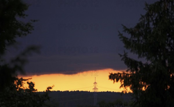 Landscape in the evening with high-voltage pylon, Germany