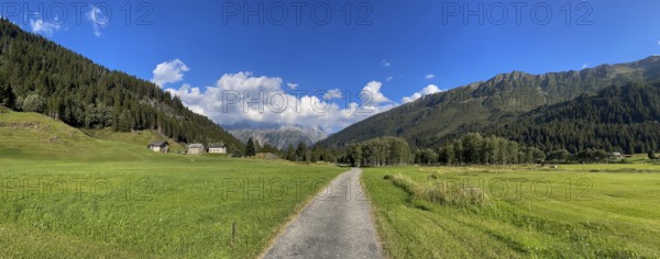 Small road and mountain huts in high valley, Campra, Lukmanier Pass, Blenio, Ticino, Switzerland