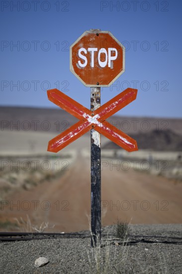 Stop sign at an ungated level crossing on the Lüderitz-Keetmanshoop railway line, near Goageb, Karas region, Namibia