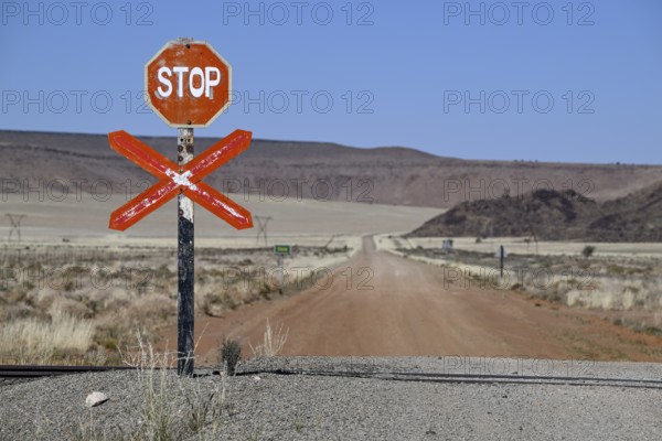 Stop sign at an ungated level crossing on the Lüderitz-Keetmanshoop railway line, near Goageb, Karas region, Namibia