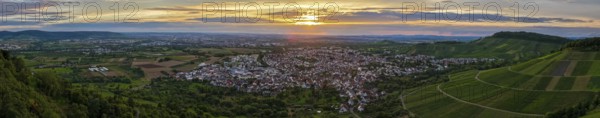 Vineyards and town in front of an impressive sunset under a dramatic sky, Korb im Remstal, Baden-Württemberg, Germany