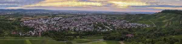Tranquil twilight view of a town surrounded by green fields and rolling hills, Korb im Remstal, Baden-Württemberg, Germany