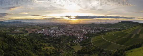View of a town at sunset, surrounded by green hills and fields, Korb im Remstal, Baden-Württemberg, Germany