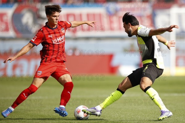 Football, Bundesliga 1, Matchday 3, 2025/2026, 1. FC Heidenheim vs. Borussia Dortmund, 13/09/2025, Voith-Arena, Heidenheim, Germany, Mathias HONSAK 1. FC Heidenheim left in duel with Ramy BENSEBAINI Borussia Dortmund 5