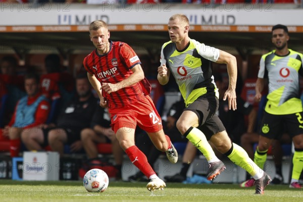 Football, Bundesliga 1, Matchday 3, 2025/2026, 1. FC Heidenheim vs. Borussia Dortmund, 13.09.2025, Voith-Arena, Heidenheim, Germany, Adrian BECK 1. FC Heidenheim 21 left in duel with Julian RYERSON Borussia Dortmund 26
